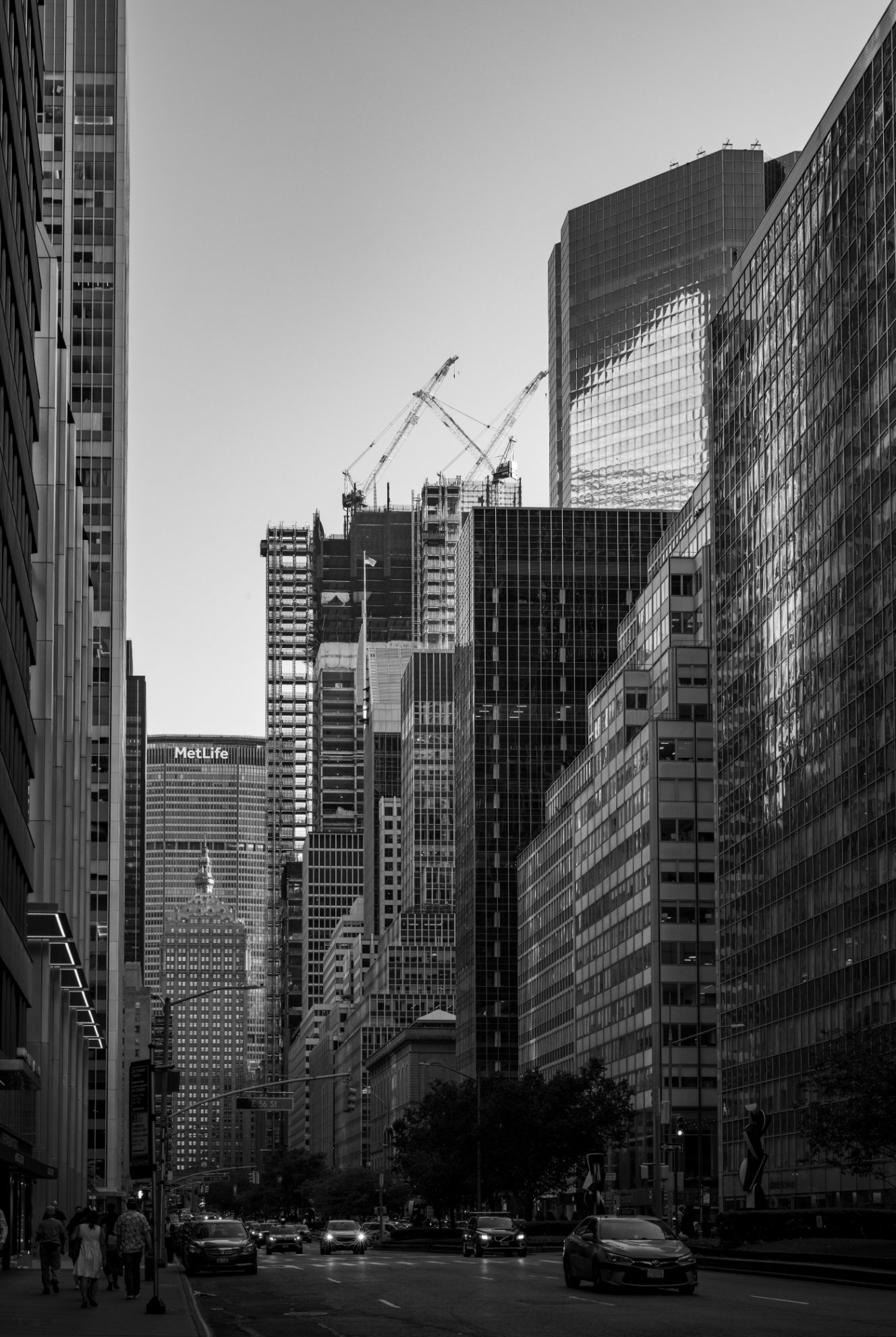 Construction cranes and glass towers rising in midtown Manhattan